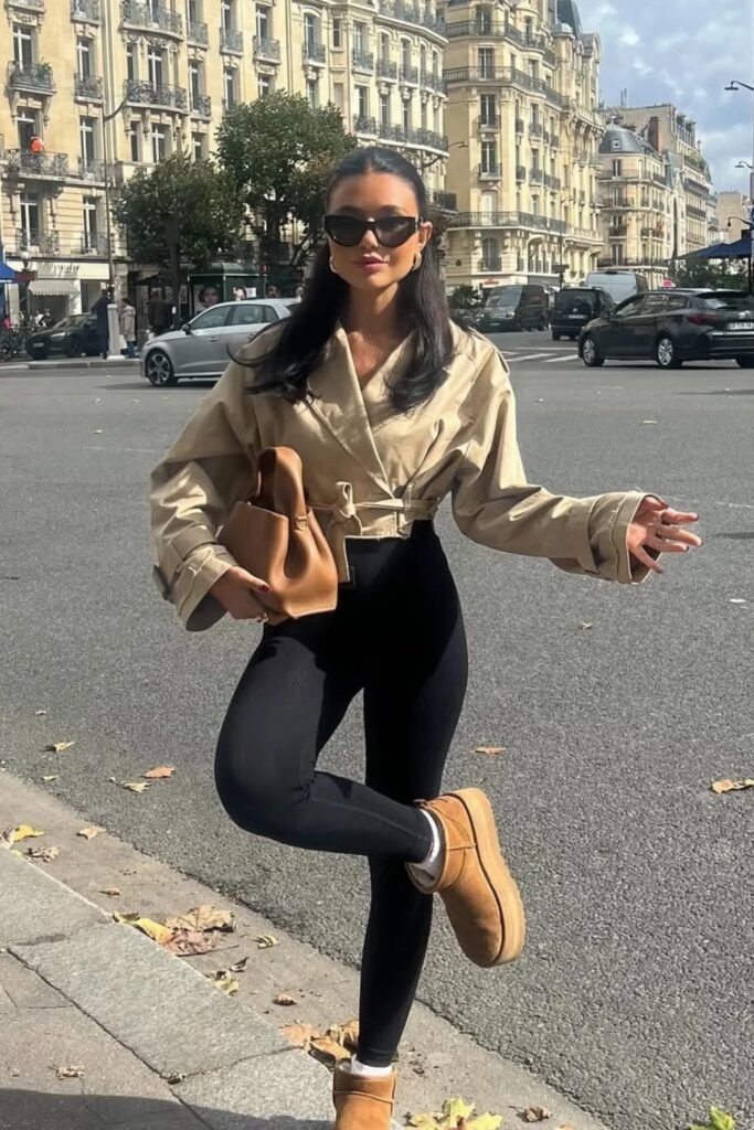 Beige Cropped Trench Coat + Black Leggings + Brown Mini Ugg Boots + Brown Handbag + Cat-Eye Sunglasses
