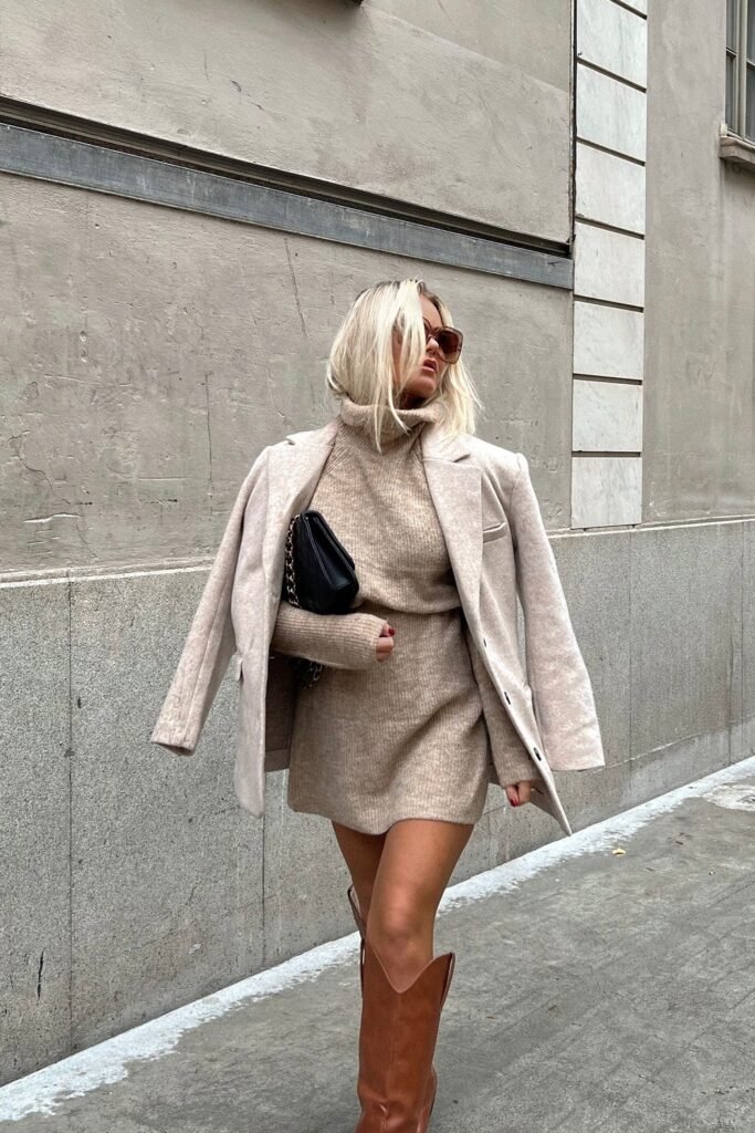 Beige Knit Blazer + Beige Knit Turtleneck Dress + Brown Knee-High Cowboy Boots + Black Quilted Shoulder Bag + Sunglasses