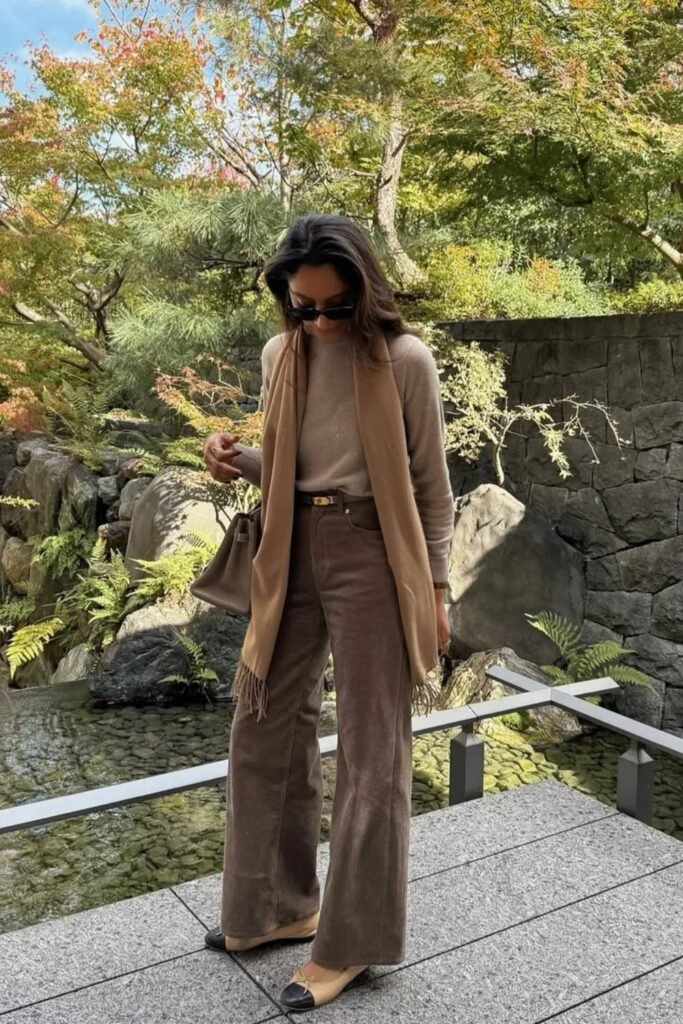 Beige Knit Sweater + Brown Flared Corduroy Pants + Camel Long Scarf + Taupe Structured Bag + Beige & Black Cap-Toe Flats