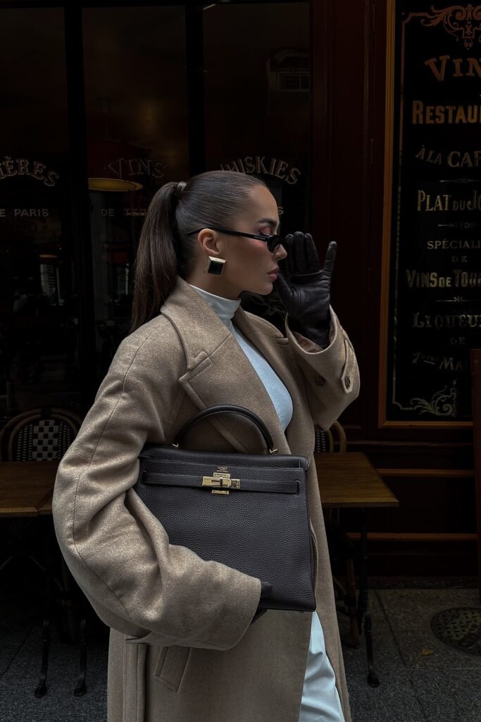 Beige Oversized Coat + White Turtleneck Dress + Black Leather Gloves + Dark Brown Kelly Bag