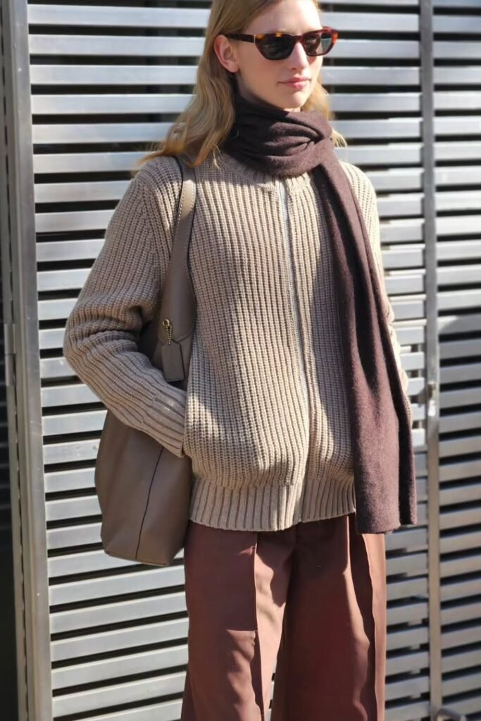 Beige Ribbed Zip-Up Sweater + Brown Wide-Leg Trousers + Dark Brown Scarf + Taupe Shoulder Bag + Sunglasses