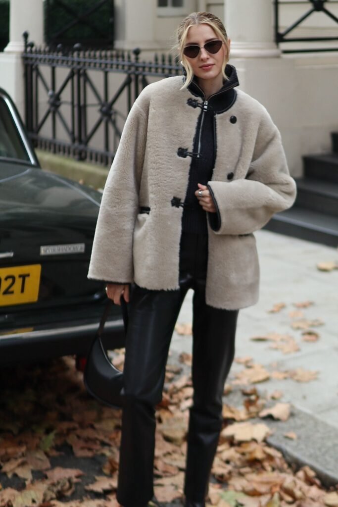 Beige Shearling Coat + Black Sweater + Black Leather Pants