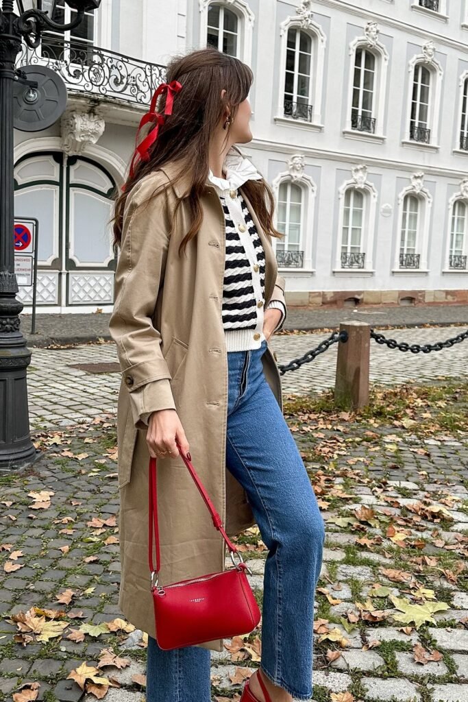 Beige Trench Coat + Striped Knit Sweater + Blue Jeans + Red Shoulder Bag