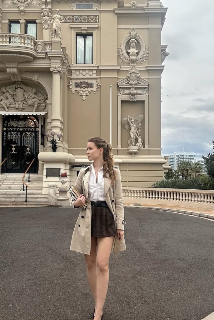 Beige Trench Coat + White Button-Down Shirt + Brown Houndstooth Mini Skirt + Black Belt + Black Pumps