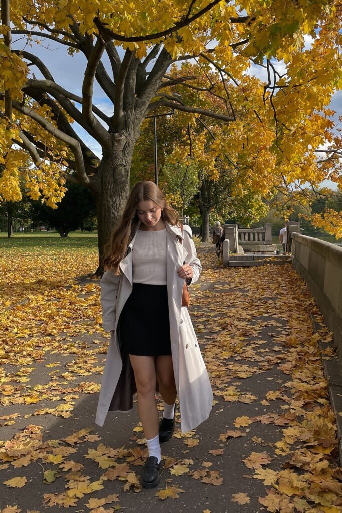 Beige Trench Coat + White Sweater + Black Mini Skirt + Black Loafers with White Socks + Brown Shoulder Bag