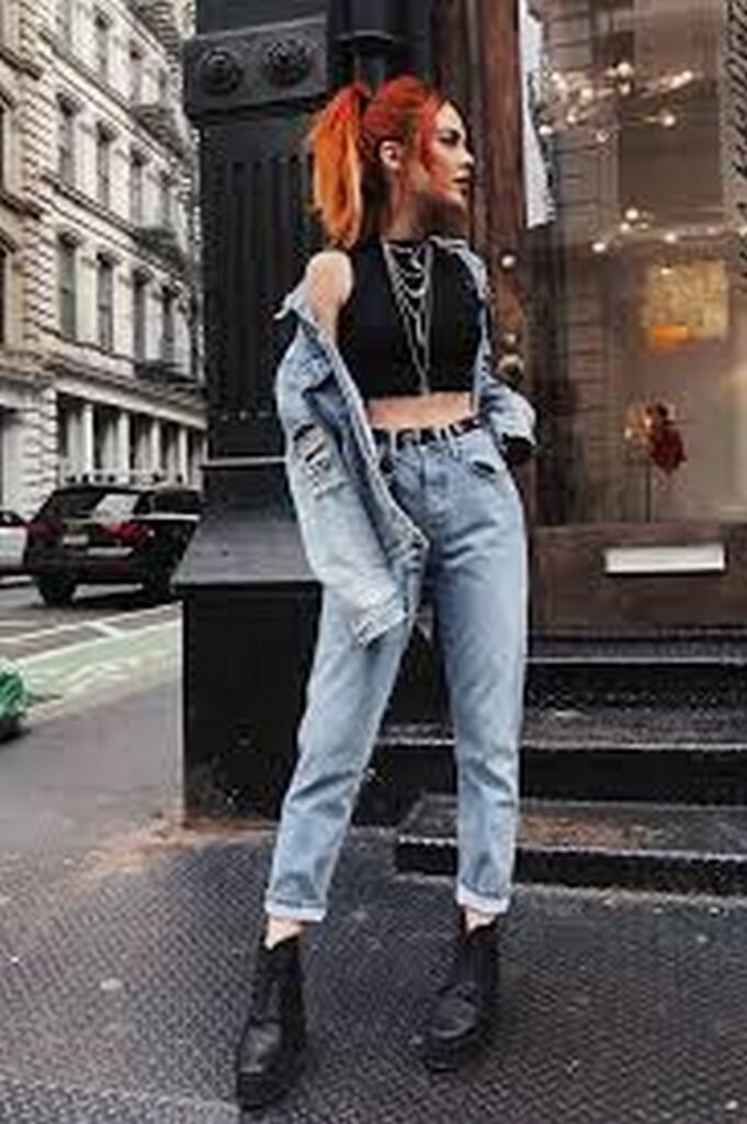 Black Crop Top + Light Wash High-Waisted Jeans + Oversized Denim Jacket + Layered Chains + Black Boots