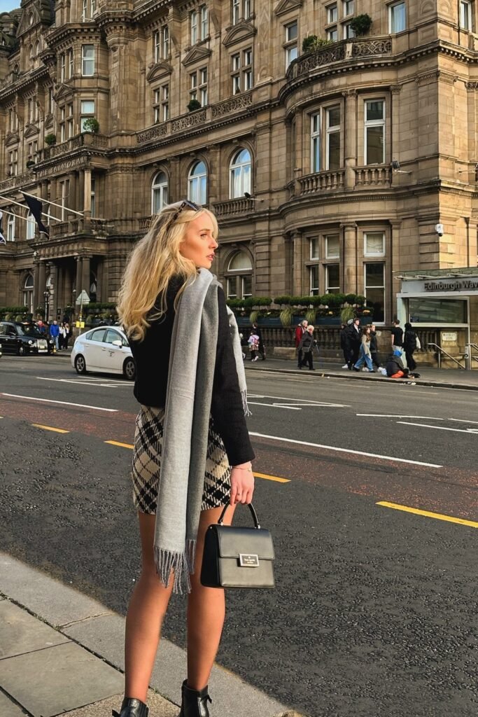 Black Cropped Jacket + Beige Plaid Mini Skirt + Grey Scarf + Black Structured Handbag + Black Ankle Boots