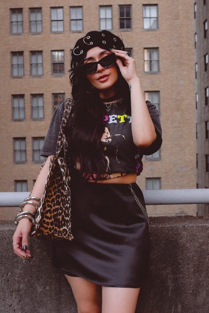 Black Graphic Crop Top + Black Satin Mini Skirt + Leopard Print Tote Bag + Safety Pin Embellished Beret + Sunglasses