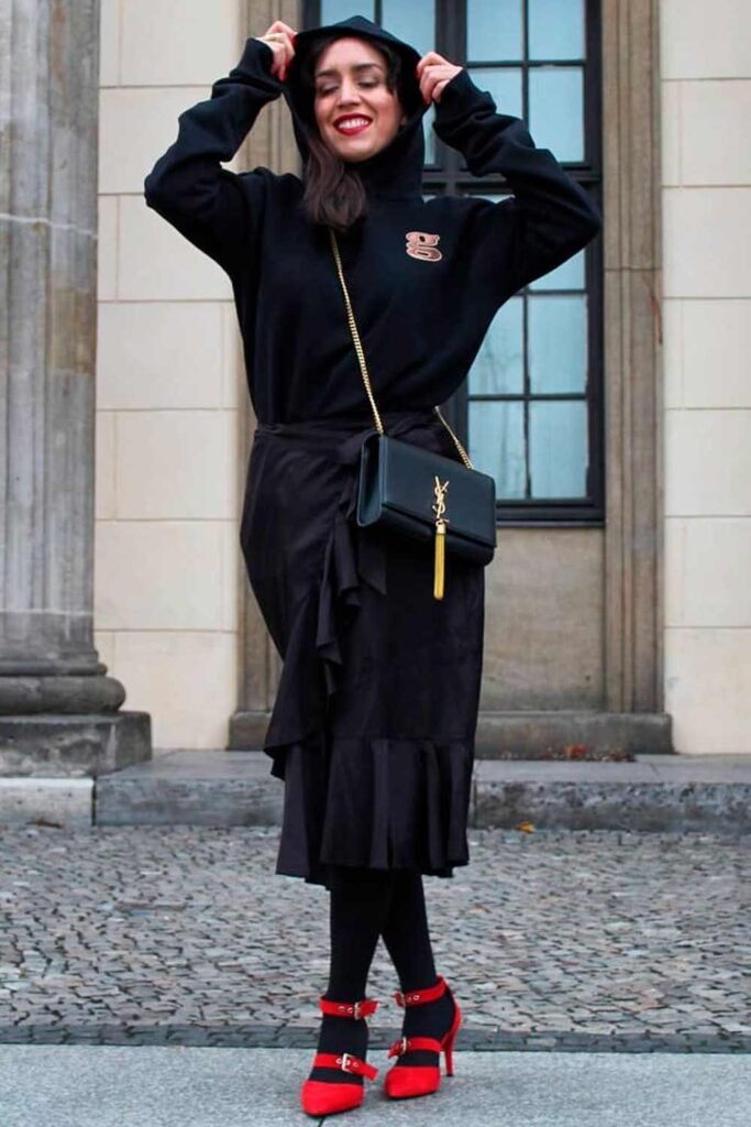 Black Hoodie + Black Ruffle Midi Skirt + Black Tights + Red Strappy Heels + Crossbody Bag