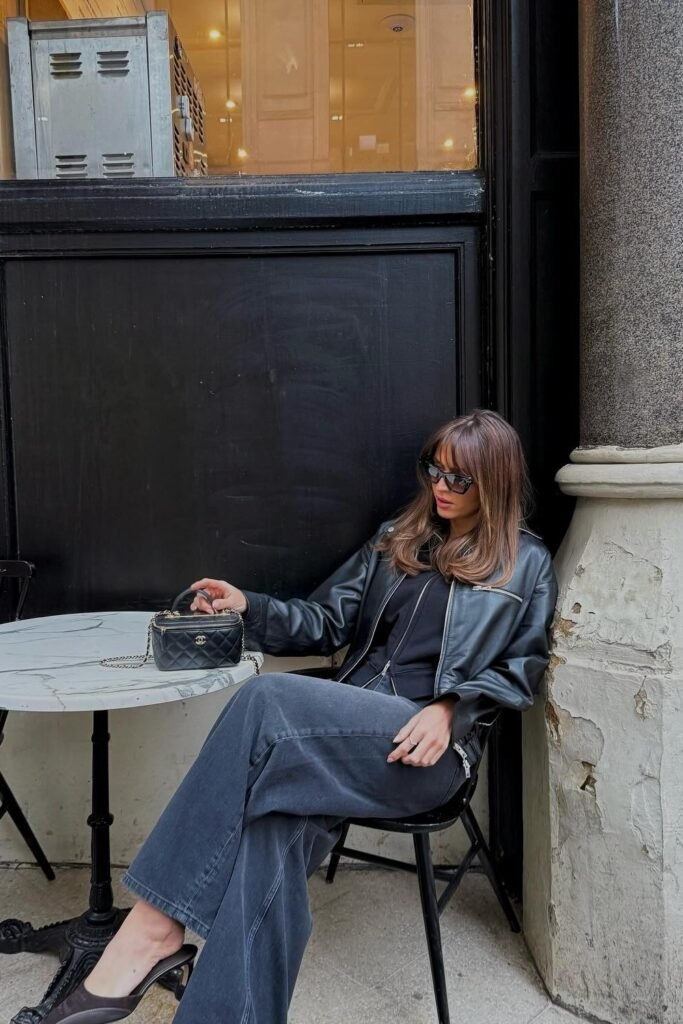 Black Leather Jacket + Black Knit Top + Dark Wide-Leg Jeans + Quilted Chanel Mini Bag + Black Heels