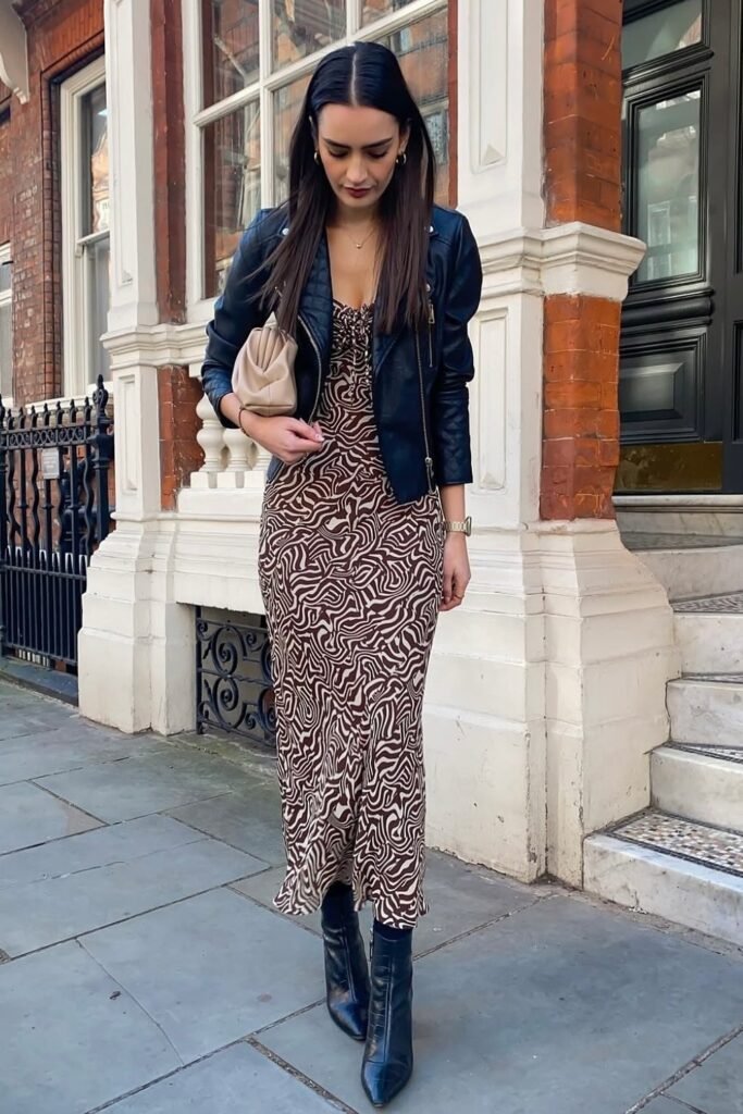 Black Leather Jacket + Brown Printed Slip Dress + Black Pointed Boots + Beige Clutch