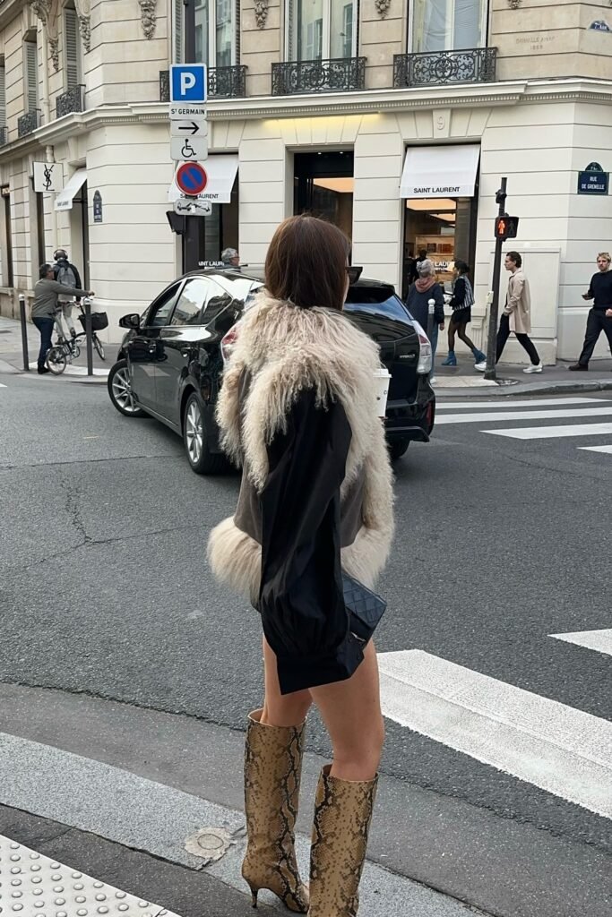 Black Mini Dress + Black Oversized Jacket with Shearling Vest + Snakeskin Knee-High Boots + Black Chanel Bag
