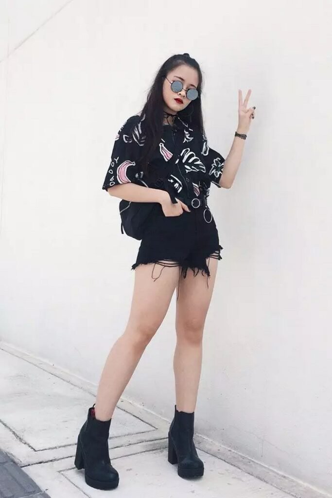Black Printed Oversized Shirt + Black Distressed Shorts + Black Chunky Heel Ankle Boots + Round Sunglasses