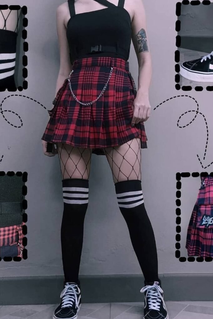 Black Strappy Crop Top + Red Plaid Pleated Mini Skirt with Chain + Fishnet Tights + Black & White Over-the-Knee Socks + Black Vans Sneakers