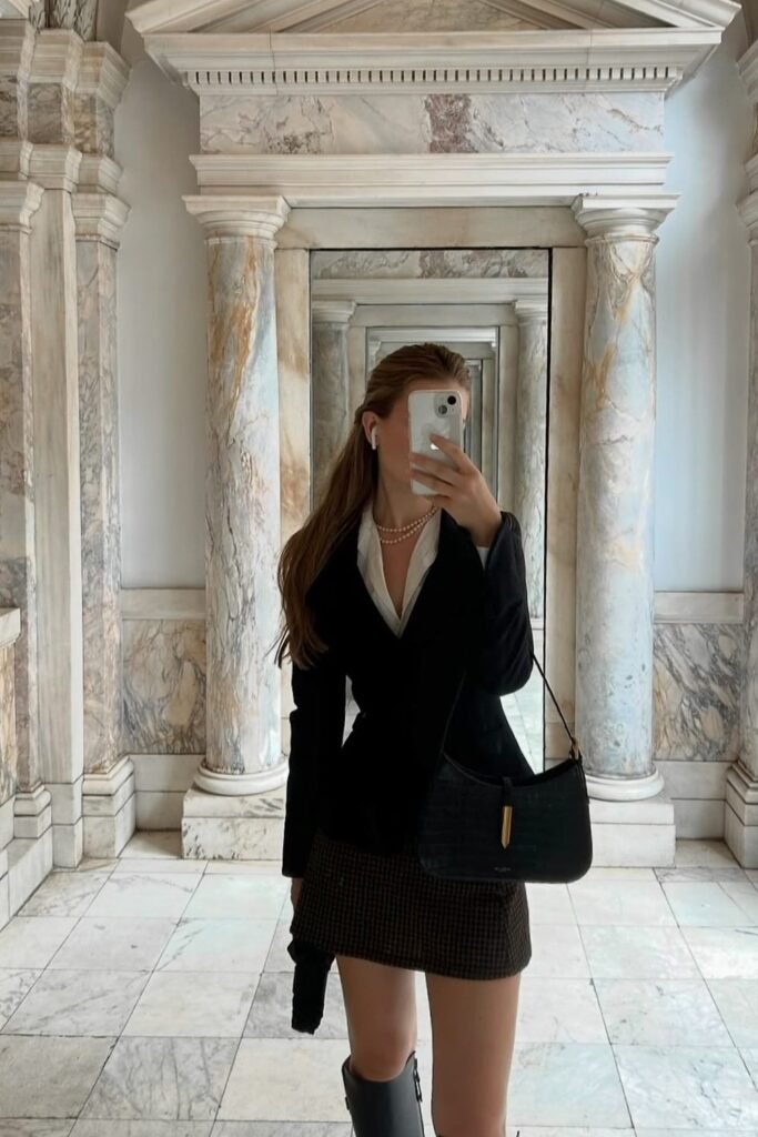 Black Tailored Blazer + White Button-Down Shirt + Brown Houndstooth Mini Skirt + Grey Knee-High Boots + Black Shoulder Bag + Pearl Necklace