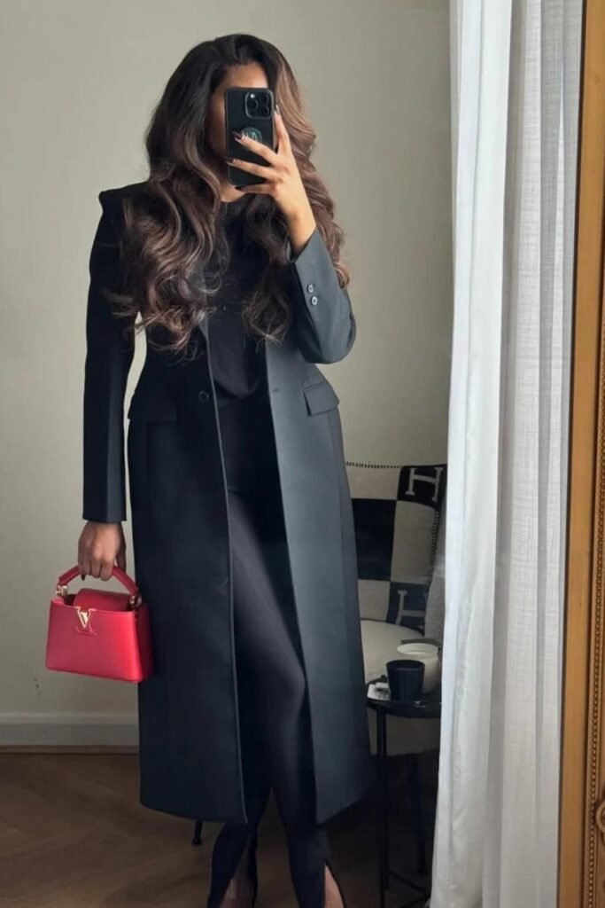 Black Top + Black Long Coat + Black Slim Pants + Red Structured Handbag