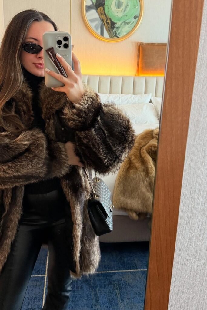 Brown Faux-Fur Coat + Black Turtleneck + Black Leather Pants + Quilted Chain Shoulder Bag + Slim Sunglasses