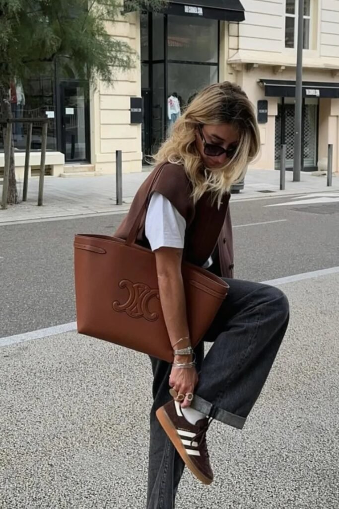 Brown Leather Vest + White T-Shirt + Black Jeans + Brown Sneakers + Large Brown Tote Bag