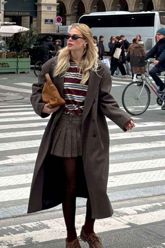 Brown Oversized Coat + Striped Burgundy & Beige Sweater + Grey Pleated Mini Skirt + Brown Loafers + Brown Clutch