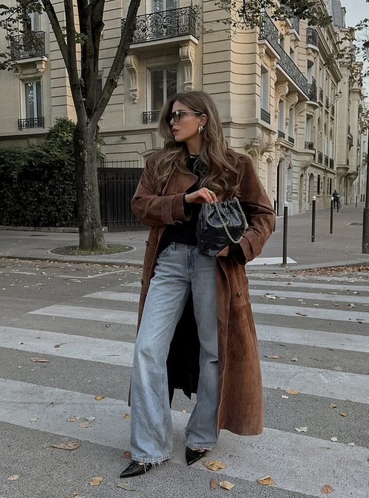 Brown Suede Long Coat + Black Top + Light Wash Wide-Leg Jeans + Black Pointed Heels + Black YSL Drawstring Bag