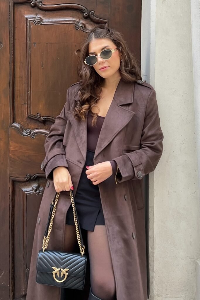 Brown Suede Trench Coat + Burgundy Top + Black Mini Skirt + Sheer Black Tights + Black Quilted Bag