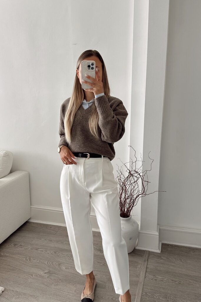 Brown V-Neck Sweater + Blue Shirt + White Tapered Pants + Black Belt + Black Flats