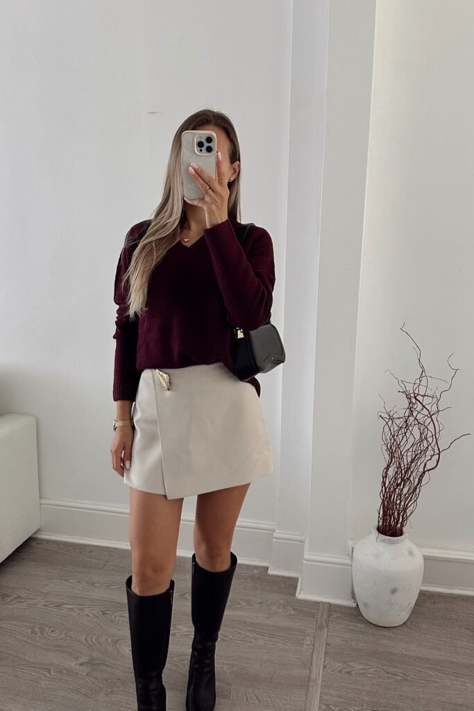 Burgundy V-Neck Sweater + Beige Mini Skirt + Black Knee-High Boots + Black Shoulder Bag