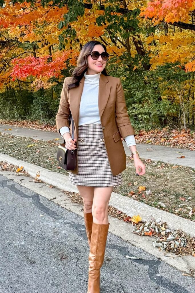 Camel Blazer + White Turtleneck + Houndstooth Mini Skirt + Tan Knee-High Boots + Brown Shoulder Bag