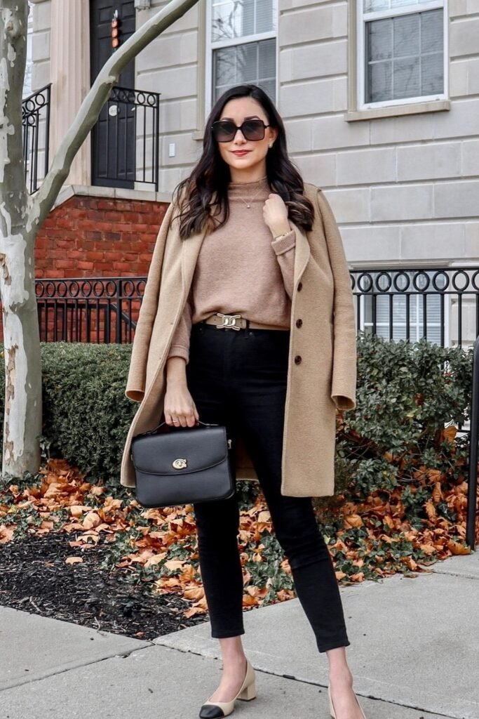 Camel Coat + Beige Sweater + Black Skinny Jeans + Beige & Black Cap-Toe Pumps + Black Structured Bag