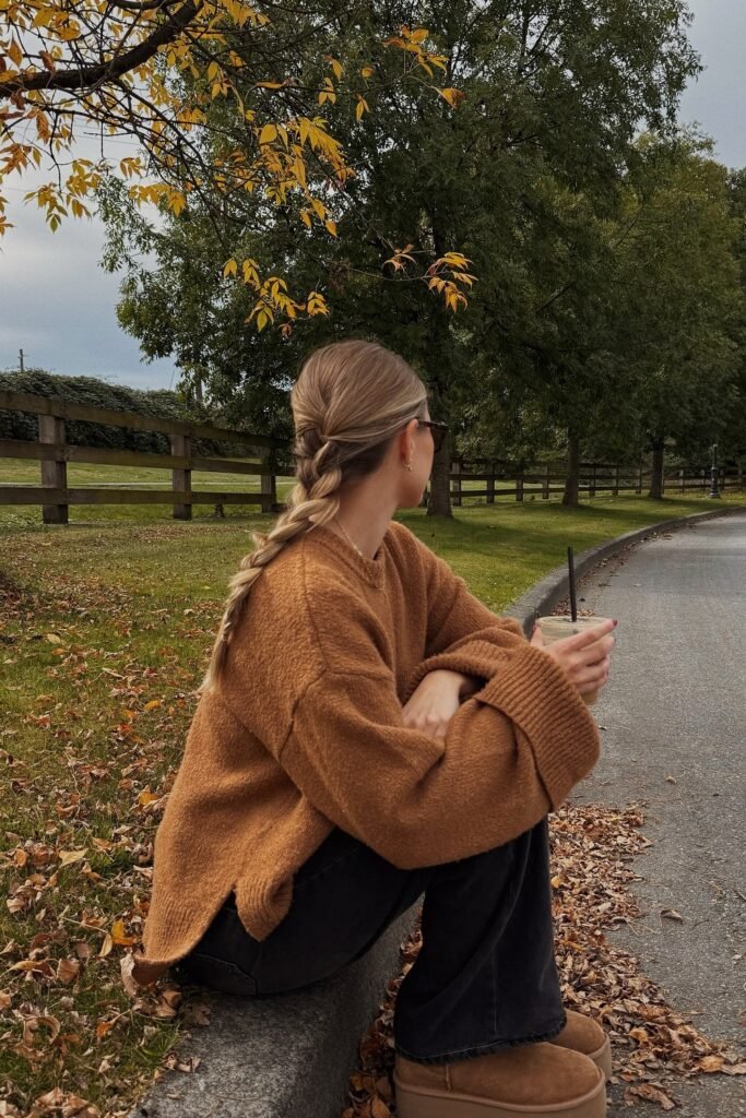 Camel Oversized Sweater + Black Wide-Leg Jeans + Platform UGG Boots + Black Sunglasses