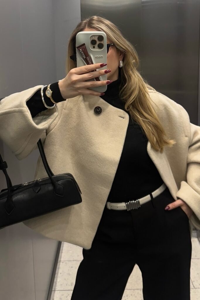 Cream Cropped Wool Jacket + Black Turtleneck + Black Tailored Trousers + White Belt + Black Top-Handle Bag