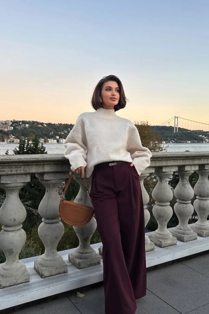 Cream Knit Turtleneck Sweater + High-Waist Burgundy Wide-Leg Trousers + Brown Half-Moon Bag