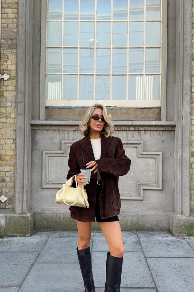 Dark Brown Corduroy Blazer + White Top + Black Mini Skirt + Black Knee-High Boots + Cream Structured Bag
