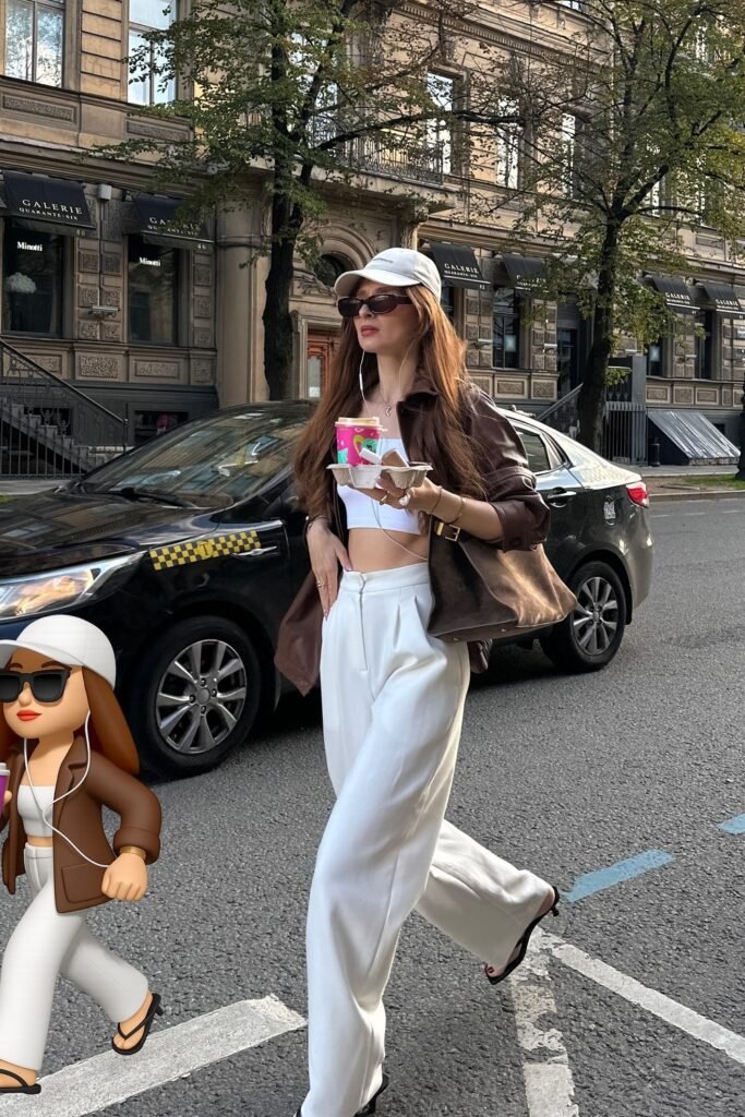 Dark Brown Leather Jacket + White Crop Top + White Wide-Leg Pants + White Cap + Brown Shoulder Bag + Black Flip-Flops + Sunglasses