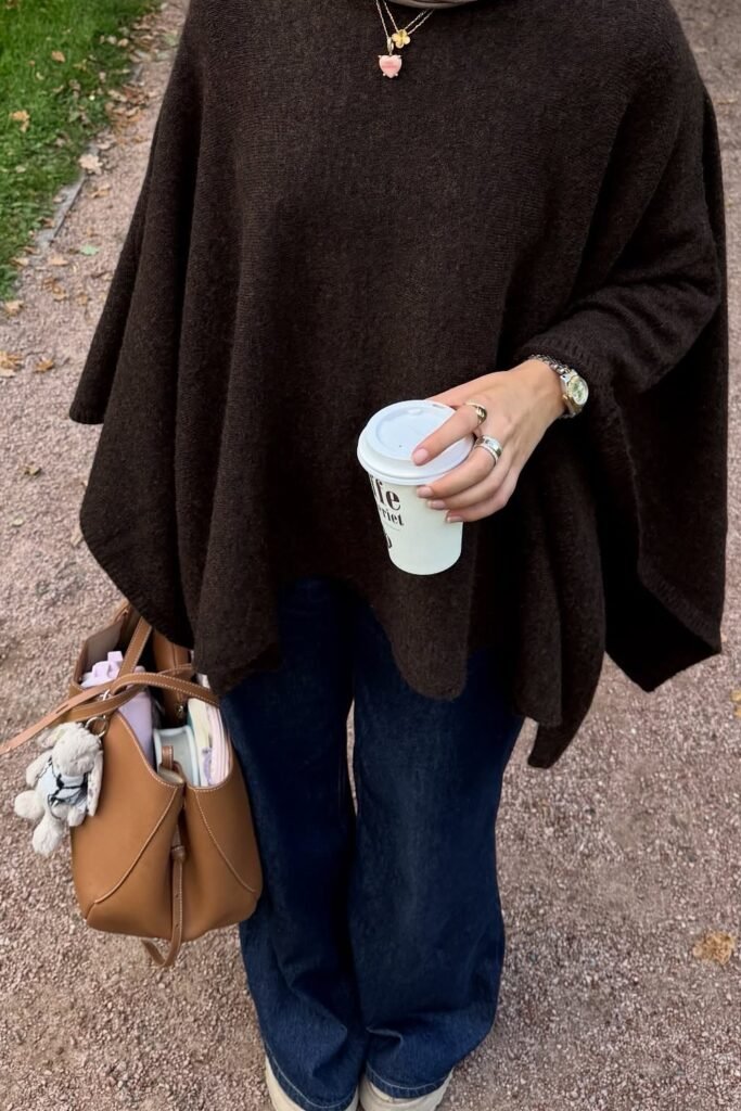 Dark Brown Poncho + Wide-Leg Jeans + White Sneakers + Tan Tote Bag with Charm