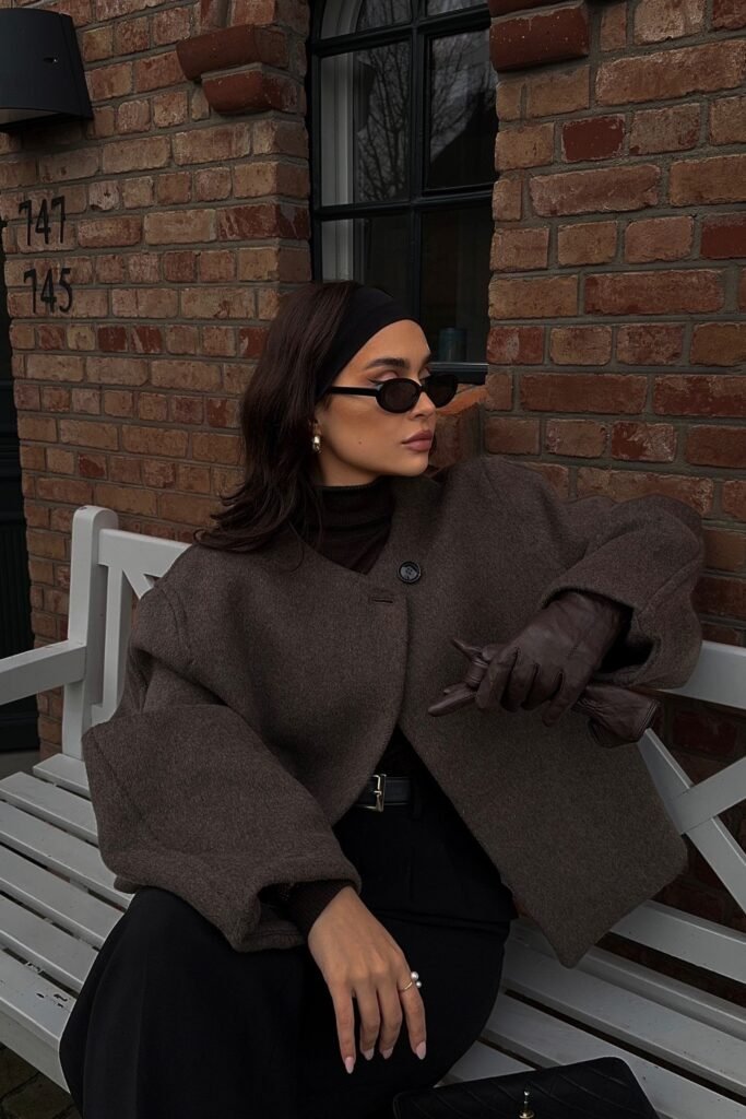 Dark Brown Wool Coat + Black Turtleneck + Black Wide-Leg Trousers + Brown Leather Gloves + Black Quilted Handbag