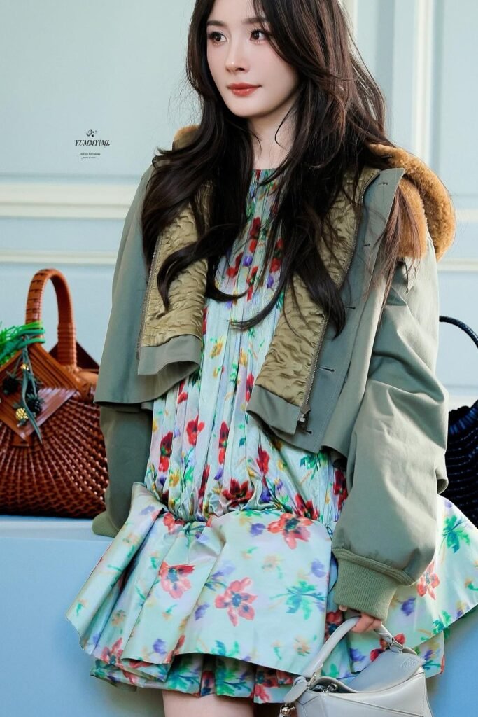 Green Bomber Jacket with Fur Hood Lining + Floral Pleated Mini Dress + Light Grey Structured Handbag