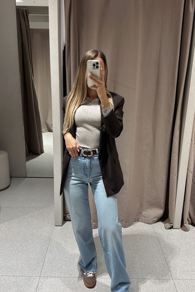 Grey Fitted Top + Black Oversized Blazer + Light Blue Wide-Leg Jeans + Brown Sneakers + Black Belt