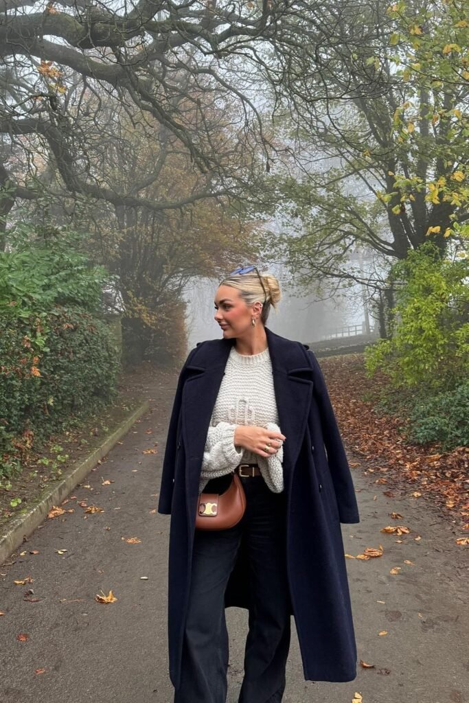 Navy Long Coat + Cream Knit Sweater + Black Wide-Leg Pants + Brown Crossbody Bag