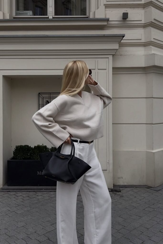 Cream Knit Sweater + White Wide-Leg Trousers + Black Bag