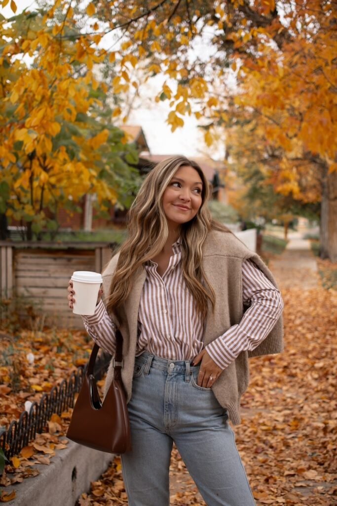 Striped Button-Down Shirt + Beige Sweater Draped + Light-Wash Jeans