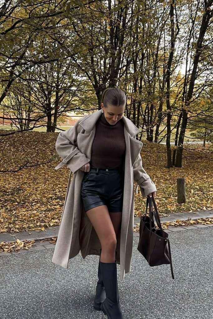 Brown Knit Turtleneck + Black Leather Shorts + Beige Oversized Coat