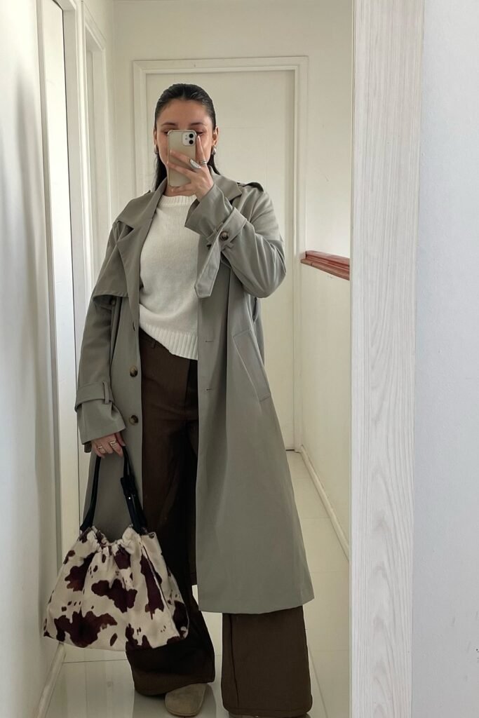 Grey Trench Coat + White Sweater + Brown Wide-Leg Pants + Cow Print Tote Bag + Beige Shoes