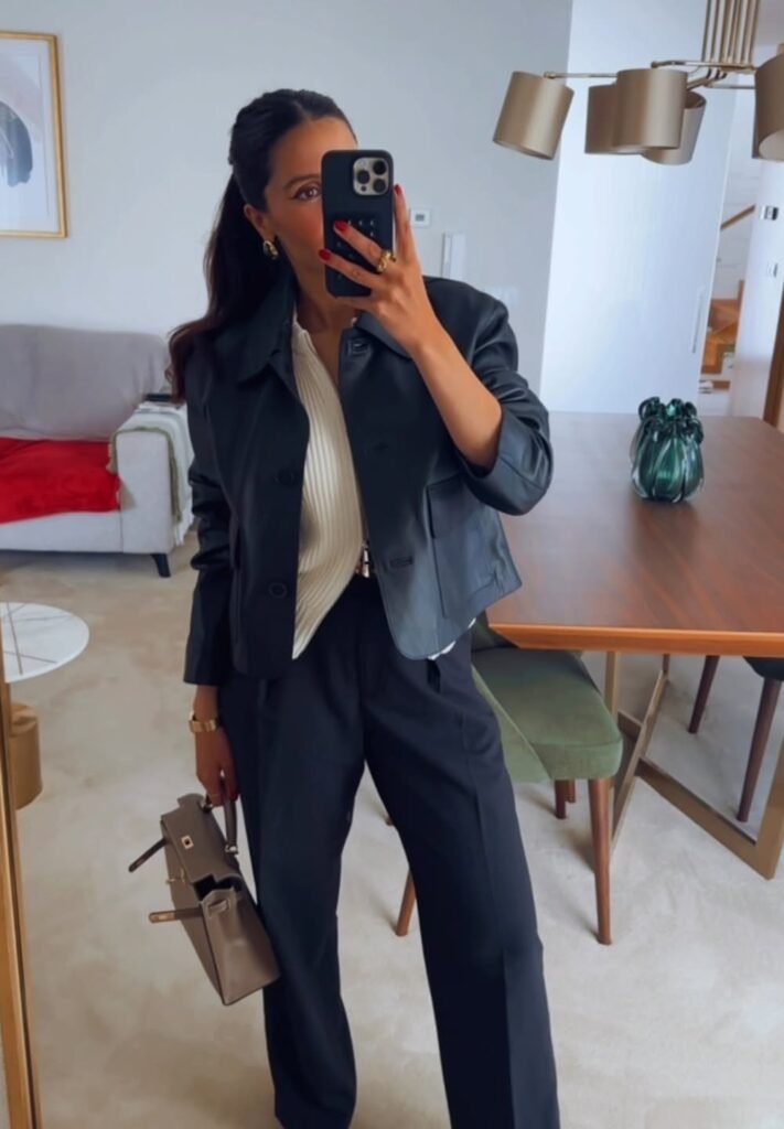 Cropped Black Leather Jacket + Cream Pleated Blouse + High-Waisted Black Trousers