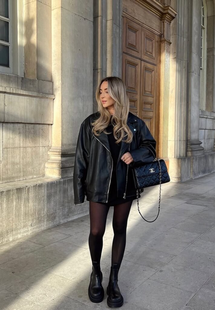 Oversized Black Leather Jacket + Black Mini Dress + Black Sheer Tights + Black Quilted Chanel Bag + Black Chunky Boots