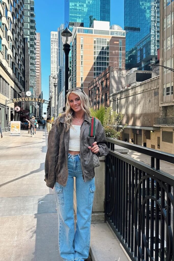 Oversized Brown Leather Jacket + White Cropped Top + Light Blue Cargo Jeans + Grey Shoulder Bag
