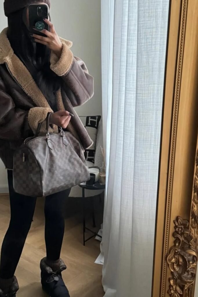 Oversized Brown Shearling Jacket + Black Leggings + Winter Boots + Large Checkered Handbag + Beanie