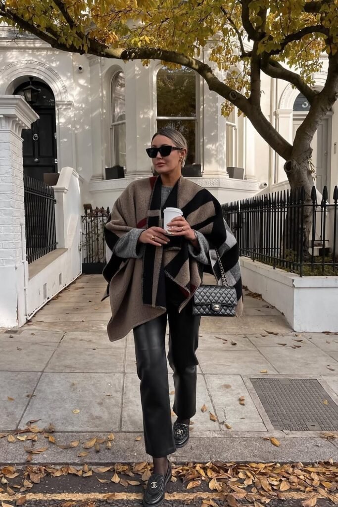 Oversized Striped Poncho + Grey Sweater + Black Straight-Leg Leather Pants + Black Chanel Loafers + Quilted Chanel Bag