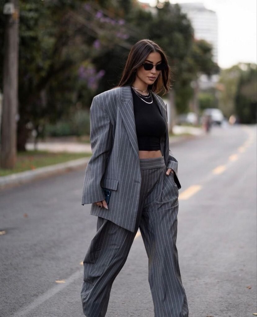 Pinstripe Oversized Suit + Black Crop Top + Wide-Leg Trousers + Layered Silver Chains