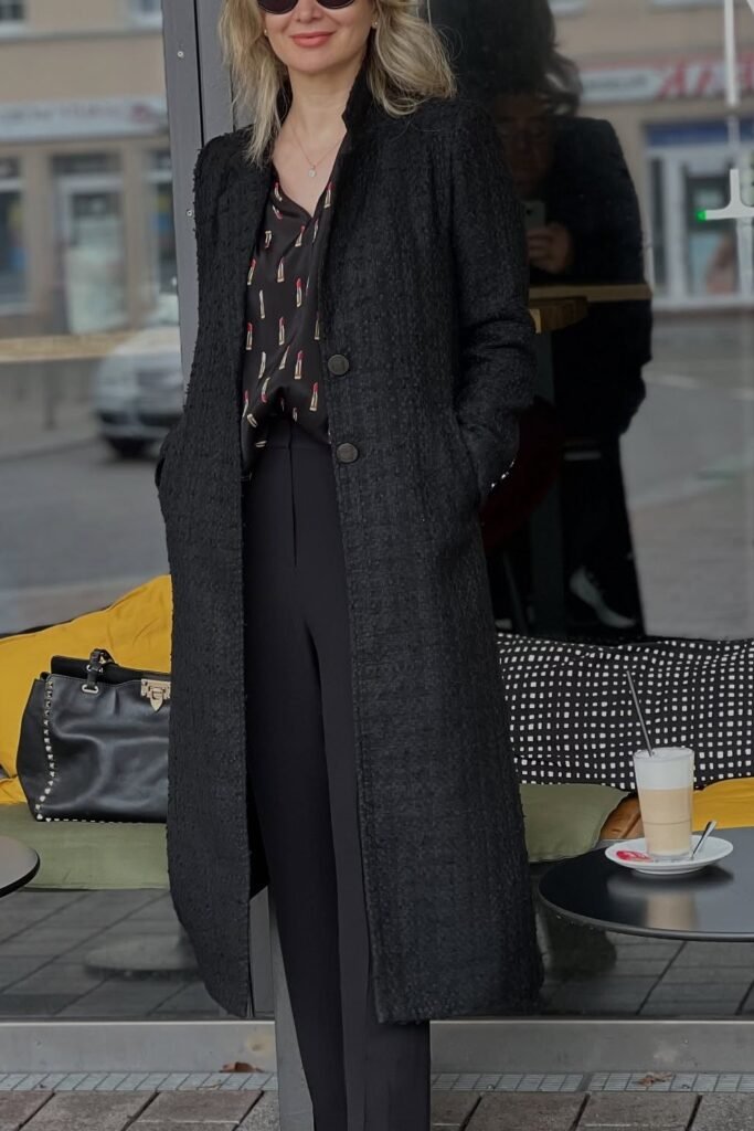 Printed Black Blouse + Long Black Textured Coat + Black Slim Pants + Black Structured Bag